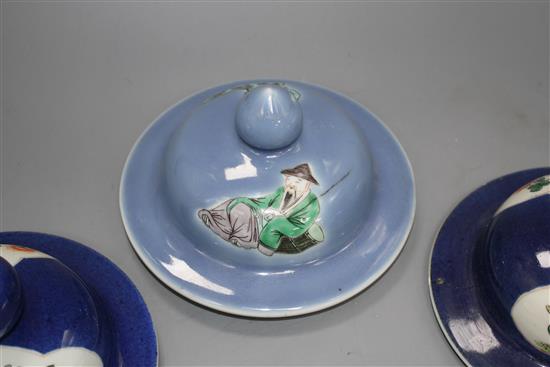 Three Chinese blue ground covers, late 19th century, including a pair with famille verte reserves, diameter approx. 17cm, internal rim